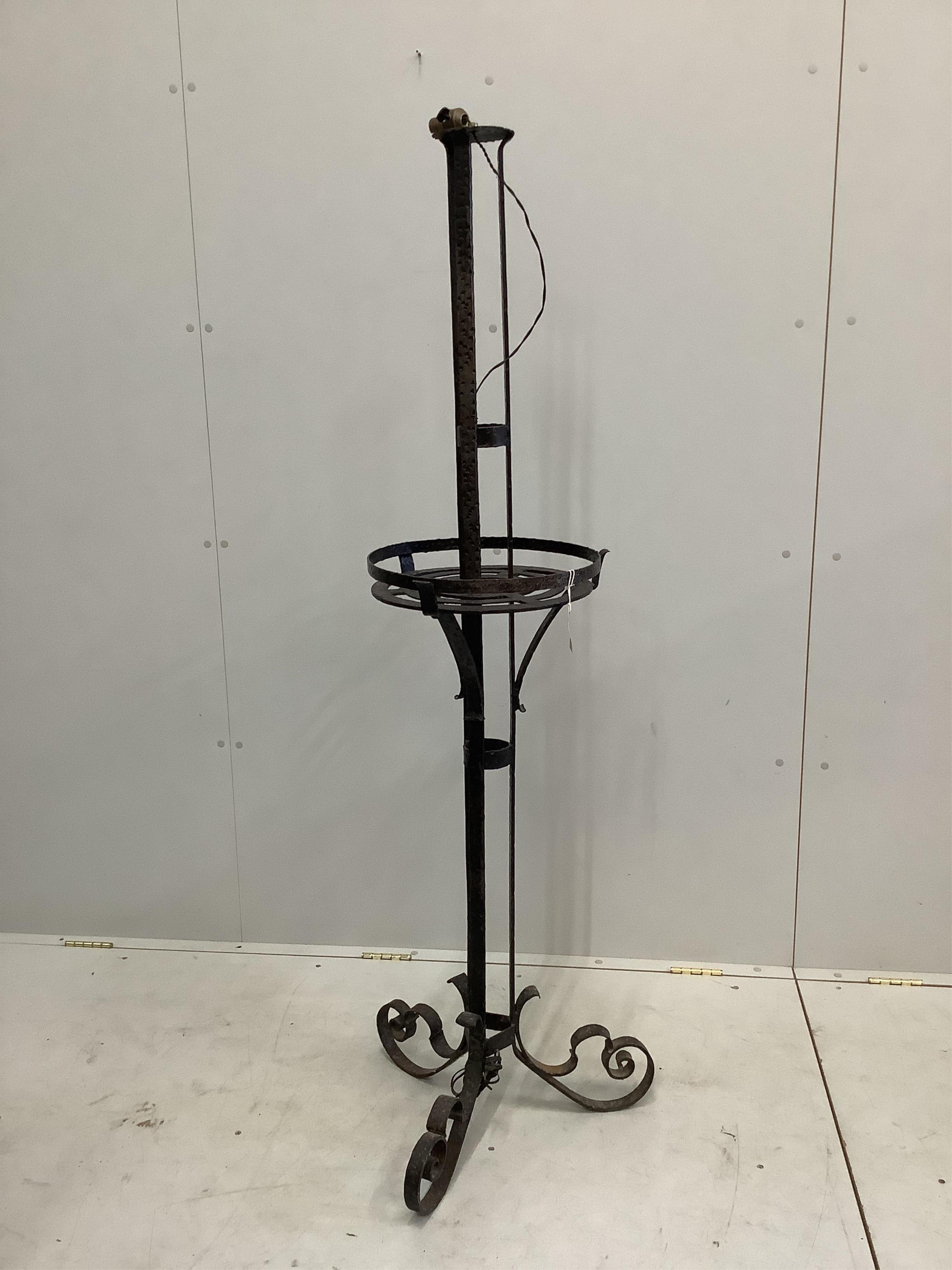 An early 20th century French wrought iron medieval style standard lamp, height 160cm. Condition - fair